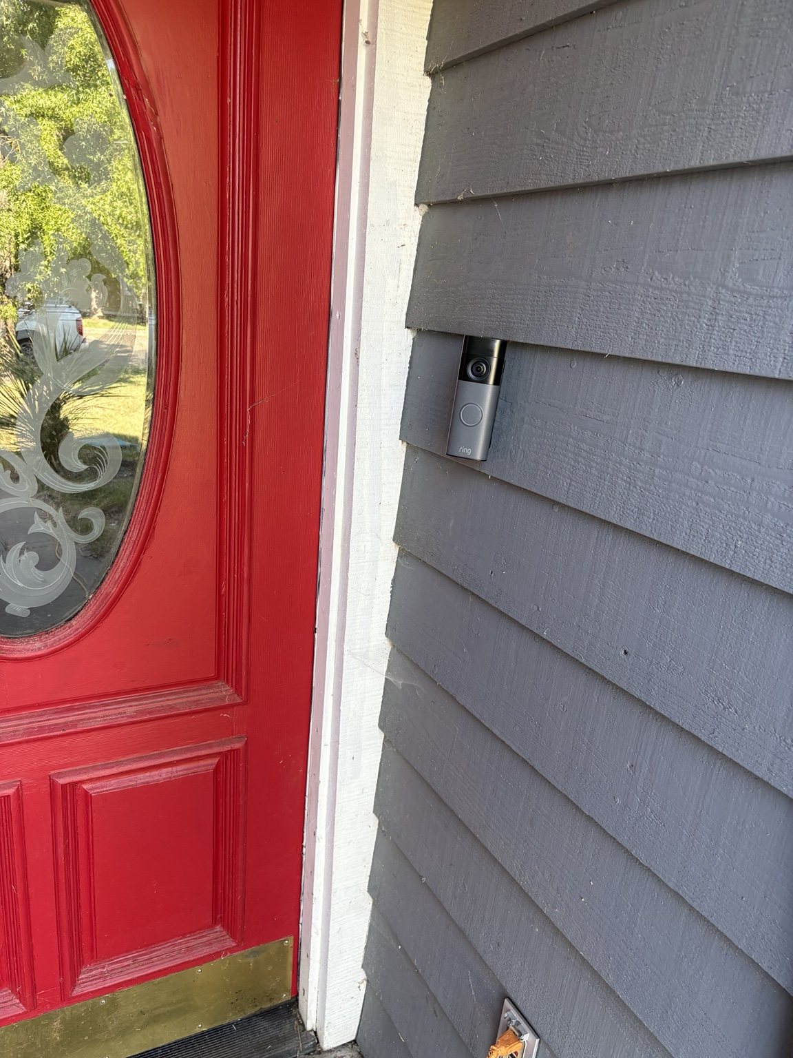 Ring video doorbell installed next to a residential front entrance